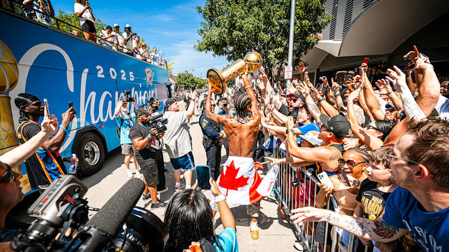 Shai Gilgeous-Alexander celebrates with fans during the Thunder's championship parade