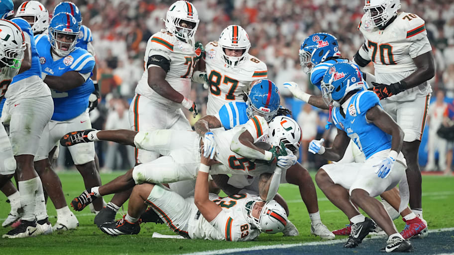 Miami running back CharMar Brown dives into the end zone to score a touchdown against Ole Miss.