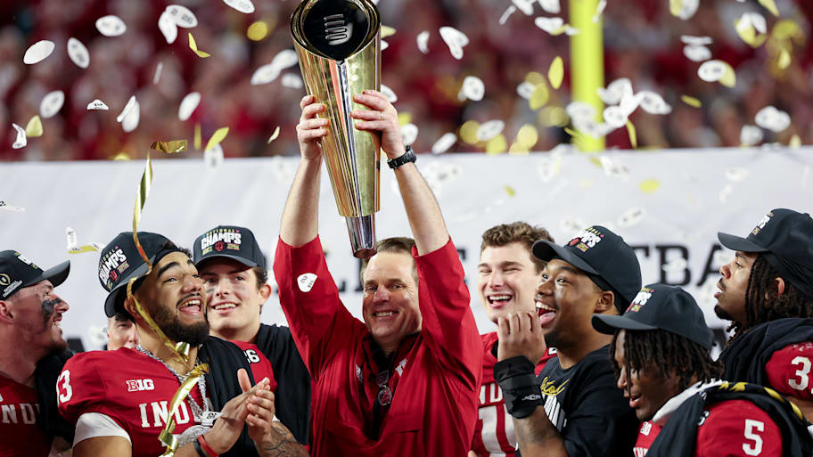 Indiana coach Curt Cignetti holds up the College Football Playoff national championship trophy.