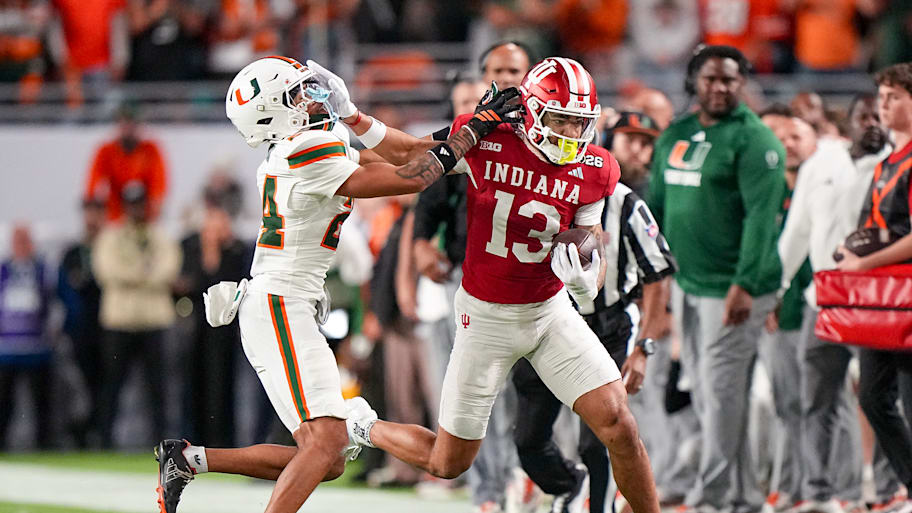 Indiana wide receiver Elijah Sarratt stiff-arms a Miami defender during the College Football Playoff national championship.