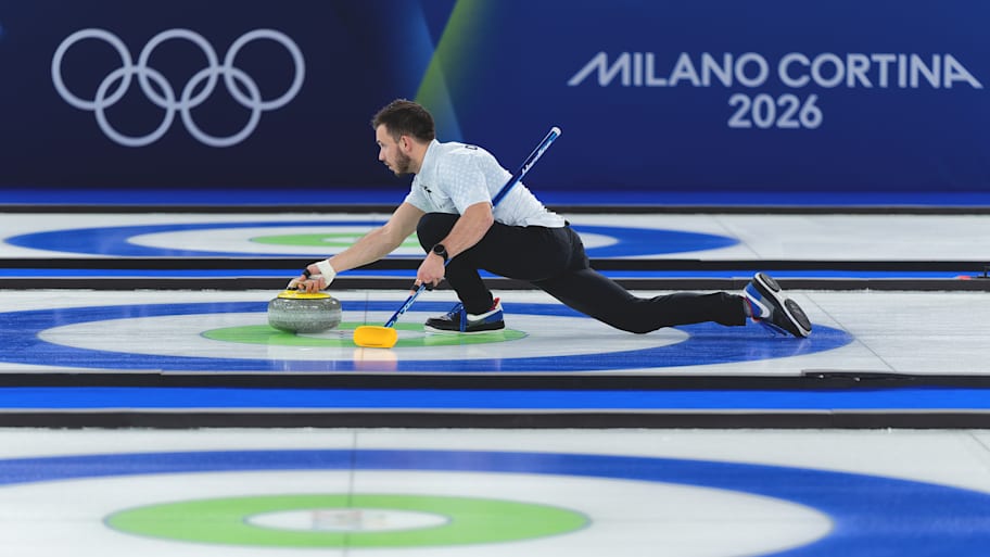 US curler Korey Dropkin takes a turn during the mixed doubles gold medal game at the 2026 Olympics.