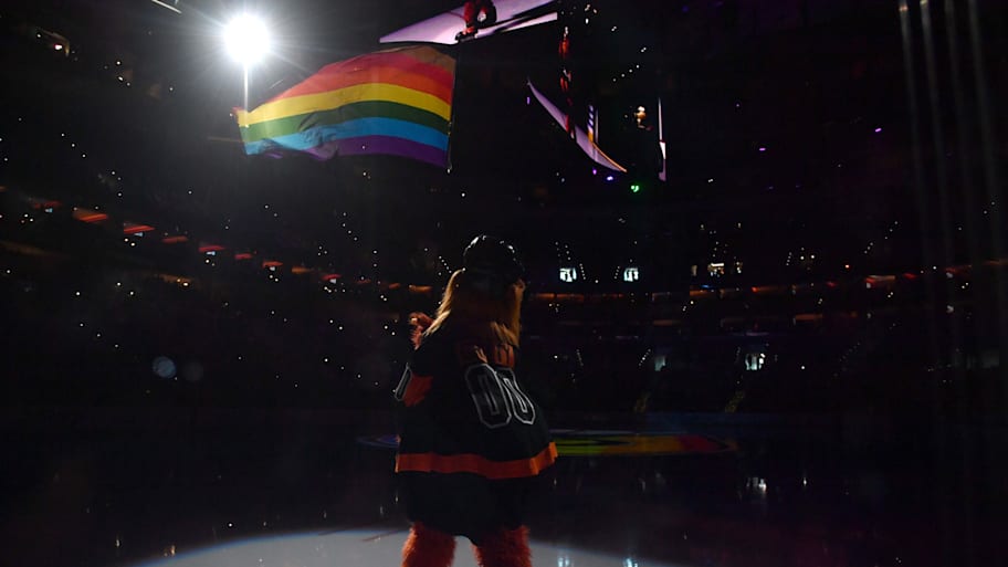 Flyers mascot Gritty waves a Pride flag