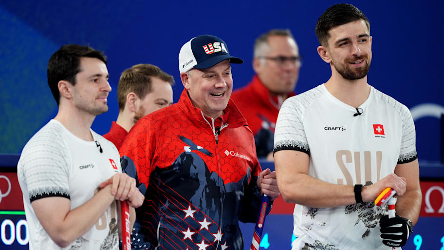 Rich Ruohonen talking with Team USA’s Swiss opponents in curling.