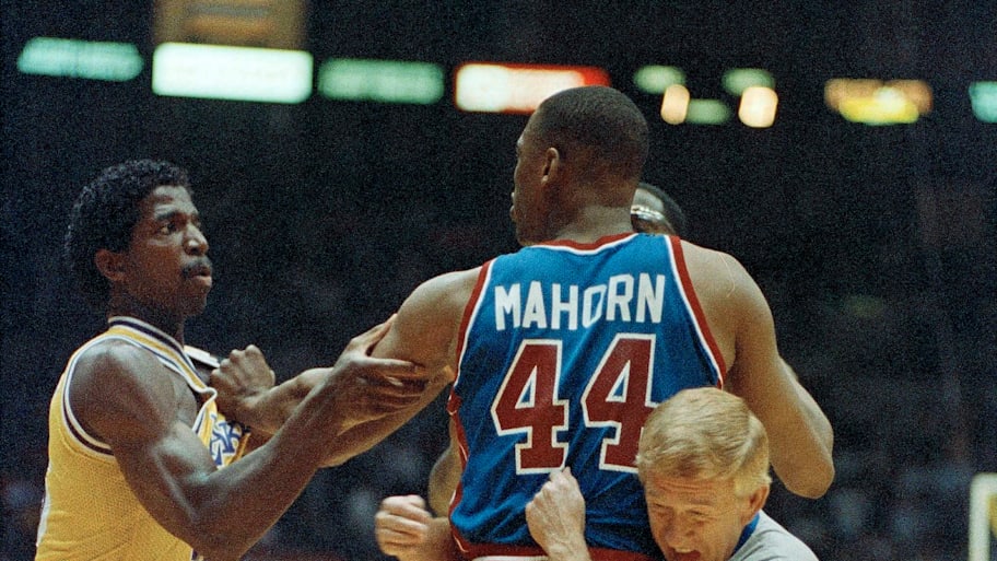 Referee Jess Kersey steps in to break up a fight between A.C. Green, left, of the Lakers, and Rick Mahorn of the Pistons.
