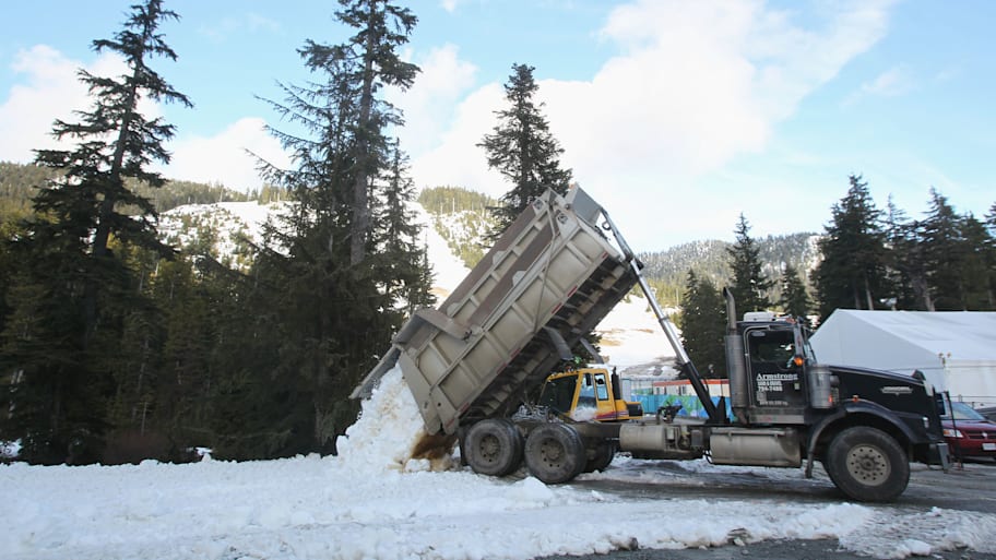 A lorry dumps snow to Cypress mountain ahead of the Vancouver 2010 Winter Olympics