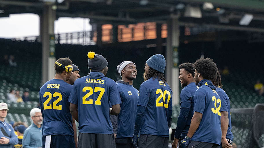 Ernest Hausmann talks to teammates at Wrigley Field.