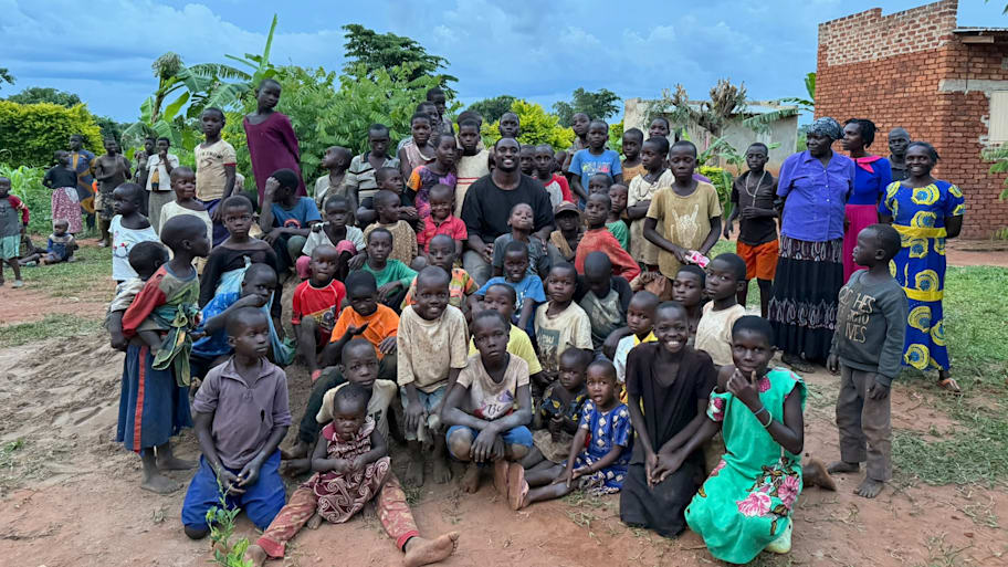Ernest Hausmann surrounded by kids in Uganda.