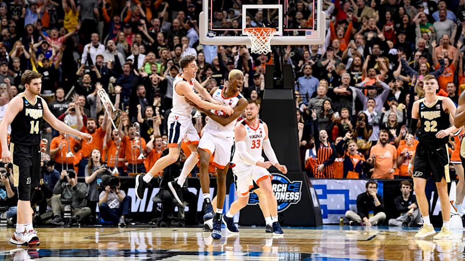 Virginia’s Mamadi Diakite celebrates with Kyle Guy (5) after making the game-tying shot to go into overtime against Purdue.