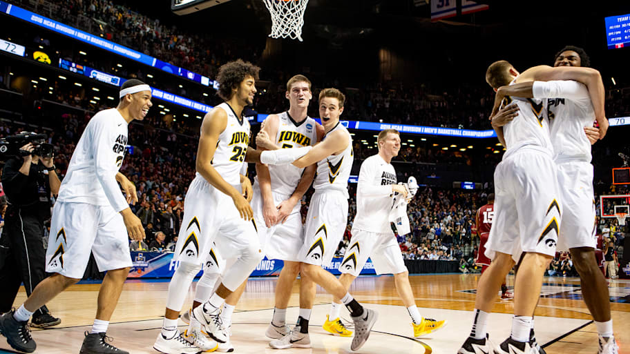 Adam Woodbury (34) celebrates with Dom Uhl (25), Jarrod Uthoff (20) and Nicholas Baer (51) after Woodbury hit the winner.