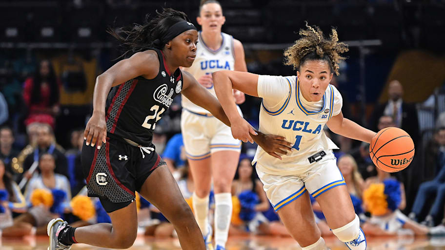 Kiki Rice drives past Raven Johnson