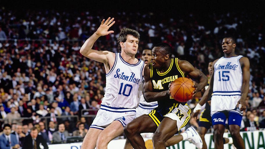 Michigan’s Rumeal Robinson dribbles against Seton Hall’s Andrew Gaze during the 1989 NCAA national championship game.