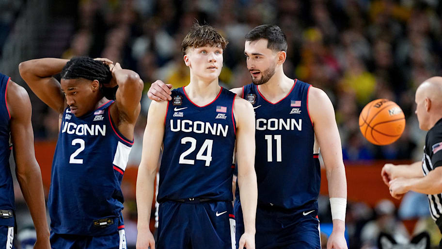 Alex Karaban talks with Braylon Mullins during the title game. His teammates praise his leadership.