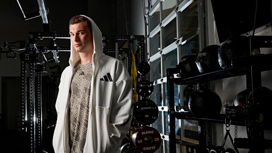 Fernando Mendoza standing in front of weights in a gym.