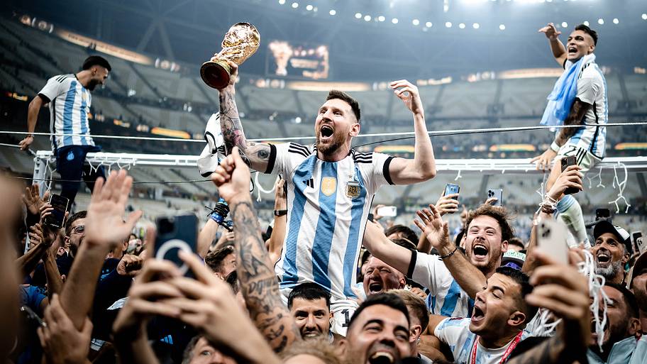 Lionel Messi hoisting the World Cup trophy