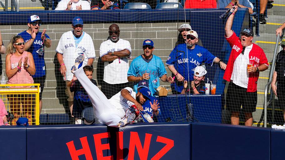 Vladimir Guerrero Jr. makes a catch in the stands