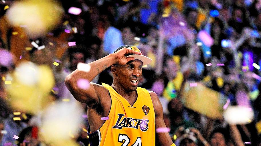 Kobe standing on a table with confetti falling down after winning his fifth championship in 2010.