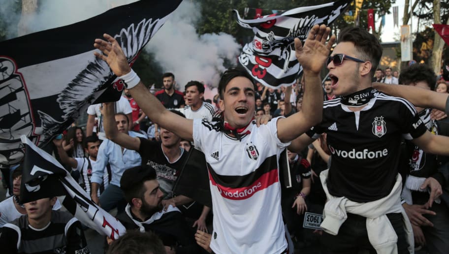 Besiktas' supporters celebrate after their team won the Turkish Super Toto league football match between Besiktas and Osmanlispor at the Vodafone Arena Stadium in Istanbul on May 19, 2016. 
Istanbul side Besiktas on May 15 clinched the Turkish Super Lig title with a game to spare, topping the league for the first time since 2009 and claiming Turkey's sole automatic Champions League spot. Besiktas won the match 3-1.  / AFP / YASIN AKGUL        (Photo credit should read YASIN AKGUL/AFP/Getty Images)