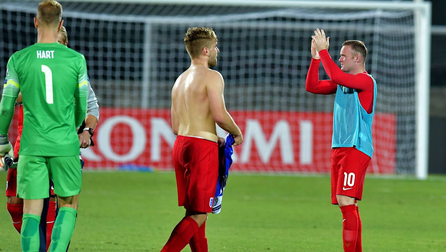 England's forward Wayne Rooney (R) applauds supporters at the end of the EURO 2016 qualifying football match San Marino vs England at the San Marino stadium in Serravalle on September 5, 2015.  AFP PHOTO / VINCENZO PINTO        (Photo credit should read VINCENZO PINTO/AFP/Getty Images)