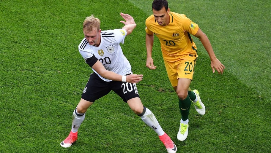 YURI CORTEZ/GettyImages Germany's midfielder Julian Brandt (L) vies for the ball against Australia's defender Trent Sainsbury during the 2017 Confederations Cup group B football match between Australia and Germany at the Fisht Stadium in Sochi on June 19, 2017. / AFP PHOTO / Yuri CORTEZ (Photo credit should read YURI CORTEZ/AFP/Getty Images)