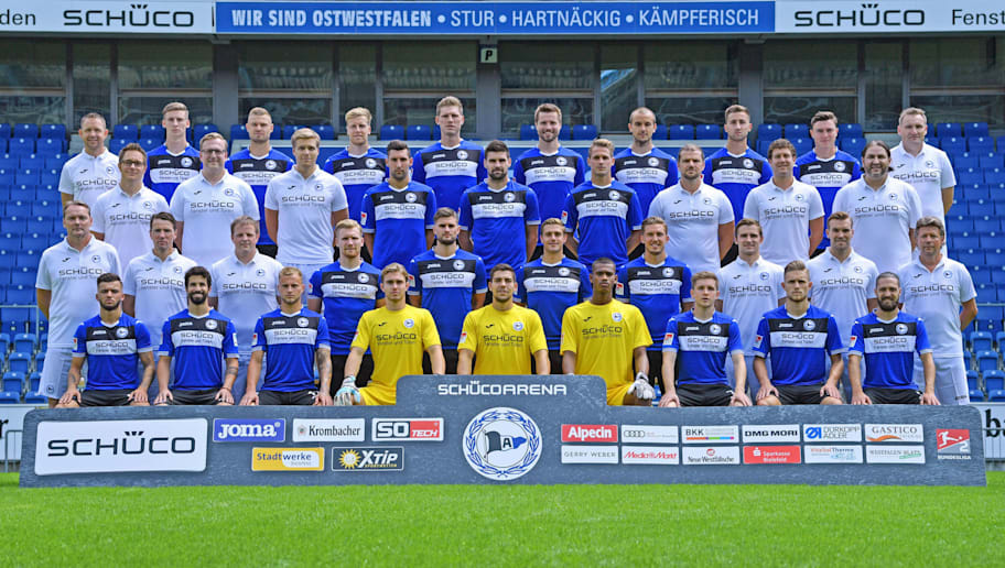 Thomas Starke/GettyImages BIELEFELD, GERMANY - JULY 22: The team (back row L-R) staff member Rainer Schonz, Henri Weigelt, Florian Hartherz, Brian Behrendt, Fabian Klos, Julian Boerner, Manuel Prietl, Andraz Sporar, Nils Quaschner and staff member Dirk Westerhold (2nd back row L-R) team doctor Dr. Andreas Elsner, team doctor Dr. Tim Niedergassel, team doctor Dr. Stefan Budde, Stephan Salger, Florian Dick, Soeren Brandy, physiotherapist Michael Schweika, physiotherapist Mario Bertling and physiotherapist Samuel da Costa (2nd front row L-R) goalkeeper coach Marco Kostmann, assistant coach Reinhard Schnittker, staff member Philipp Heithoelter, Andreas Voglsammer, Christopher Noethe, Tom Schuetz, Konstantin Kerschbaumer, assistant coach Sebastian Hille, assistant cosch Carsten Rump and head coach Jeff Saibene (front row L-R) Keanu Staude, Nils Teixeira, Christoph Hemlein, Nikolai Rehnen, Stefan Ortega Moreno, Baboucarr Gaye, Patrick Weihrauch, Leandro Putaro and David Ulm poses during the Second Bundesliga team presentation of Arminia Bielefeld at Schueco Arena on July 4, 2017 in Bielefeld, Germany. (Photo by Thomas Starke/Bongarts/Getty Images)