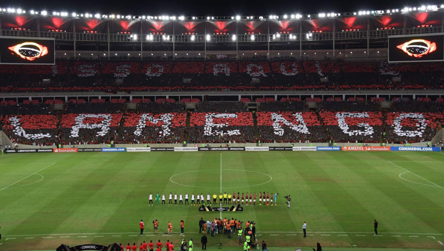 Brazil's Flamengo fans display placards to form words of support for their team before the start of the Copa Libertadores football match against Argentina's San Lorenzo at Maracana stadium in Rio de Janeiro, Brazil on March 8, 2017.  / AFP PHOTO / VANDERLEI ALMEIDA        (Photo credit should read VANDERLEI ALMEIDA/AFP/Getty Images)