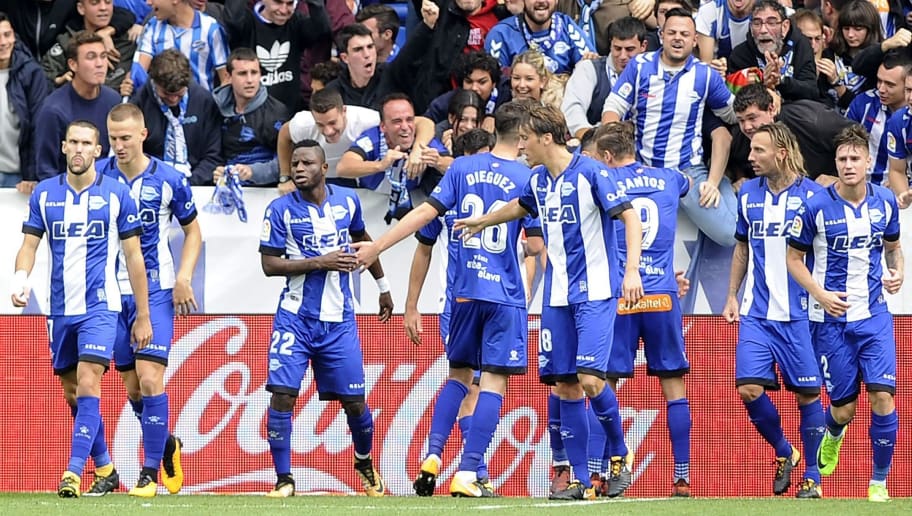 Alaves' players celebrate with supporters after scoring a goal during the Spanish league football match Deportivo Alaves vs Valencia CF at the Mendizorroza stadium in Vitoria on October 28, 2017. / AFP PHOTO / ANDER GILLENEA        (Photo credit should read ANDER GILLENEA/AFP/Getty Images)
