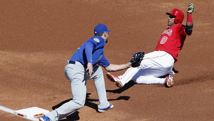 TEMPE, AZ - MARCH 06:  Yunel Escobar #0 of the Los Angeles Angels is tagged out at third by Kris Bryant #17 of the Chicago Cubs in the first inning during the spring training game at Tempe Diablo Stadium on March 6, 2017 in Tempe, Arizona.  (Photo by Tim Warner/Getty Images)