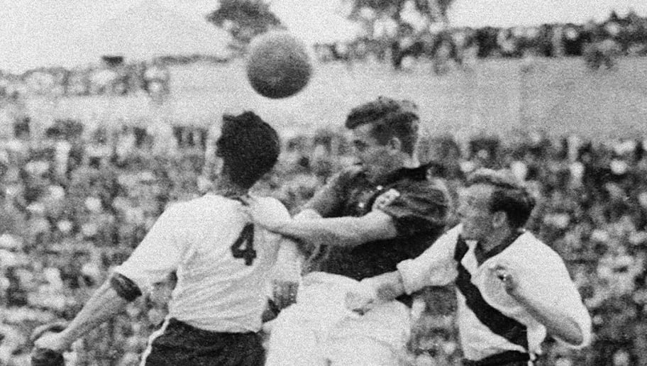 English midfielder Thomas Finney (C) tries to head the ball between American defenders Charlie Colombo and Walter Bahr 29 June 1950 in Belo Horizonte during the World Cup first-round match between England and the United States. Heavily-favored England was upset by the United States 1-0 on a goal scored by forward Joseph Gaetjens. AFP PHOTO (Photo credit should read STAFF/AFP/Getty Images)