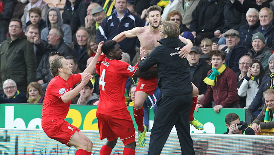 With his shirt off, Liverpool's English midfielder Adam Lallana (2nd R) celebrates scoring their late winning goal Liverpool's German manager Jurgen Klopp (R) during the English Premier League football match between Norwich City and Liverpool at Carrow Road in Norwich, eastern England, on January 23, 2016. Liverpool won the game 5-4. AFP PHOTO / LINDSEY PARNABY

RESTRICTED TO EDITORIAL USE. No use with unauthorized audio, video, data, fixture lists, club/league logos or 'live' services. Online in-match use limited to 75 images, no video emulation. No use in betting, games or single club/league/player publications. / AFP / LINDSEY PARNABY        (Photo credit should read LINDSEY PARNABY/AFP/Getty Images)