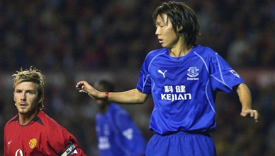 Li Tie of Everton (R) keeps an eye on David Beckham of Manchester United, 