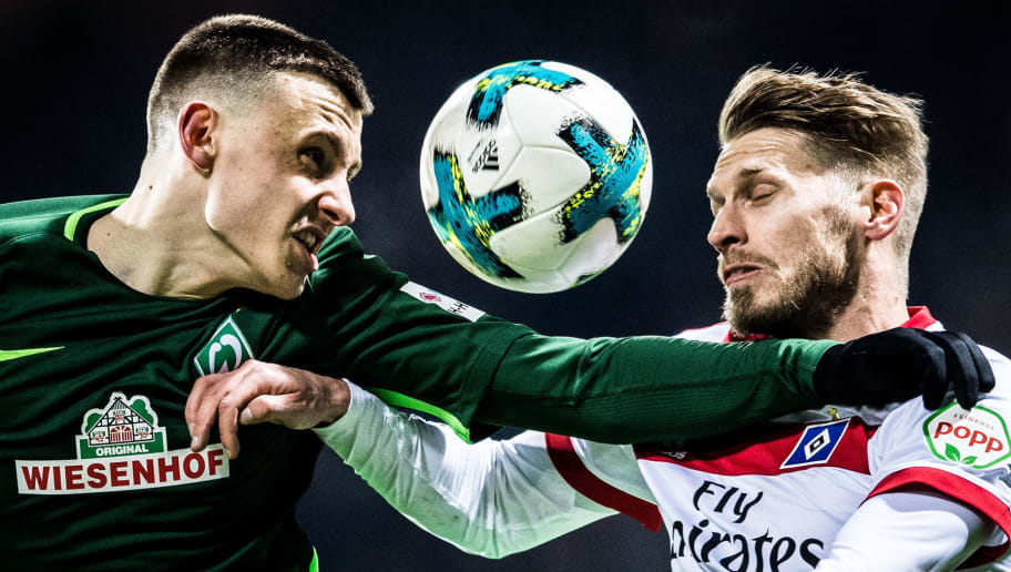 BREMEN, GERMANY - FEBRUARY 24: Maximilian Eggestein of Bremen (l) fights for the ball with Aaron Hunt of Hamburg during the Bundesliga match between SV Werder Bremen and Hamburger SV at Weserstadion on February 24, 2018 in Bremen, Germany. (Photo by Lukas Schulze/Bongarts/Getty Images)