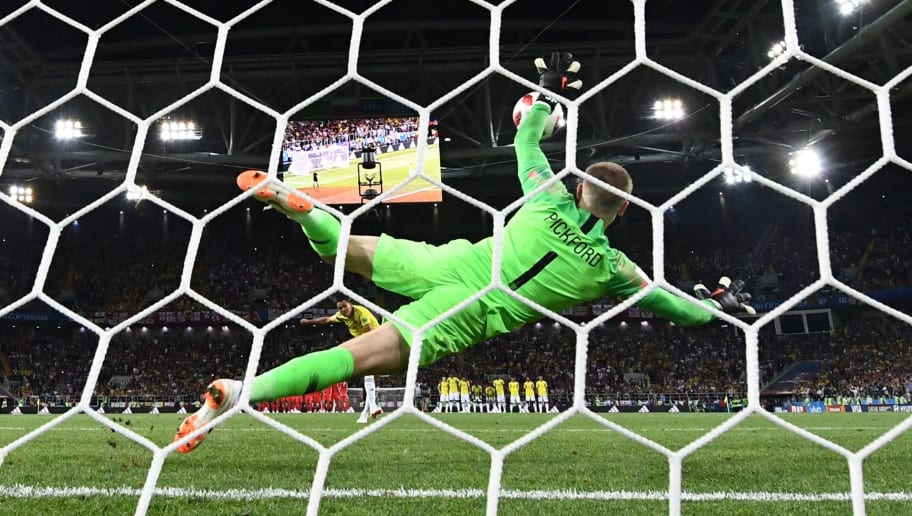 TOPSHOT - England's goalkeeper Jordan Pickford (C) jumps to catch the ball as Colombia's forward Carlos Bacca misses his penalty kick (rear C) during the penalty shoot-out of the Russia 2018 World Cup round of 16 football match between Colombia and England at the Spartak Stadium in Moscow on July 3, 2018. (Photo by FRANCK FIFE / AFP) / RESTRICTED TO EDITORIAL USE - NO MOBILE PUSH ALERTS/DOWNLOADS        (Photo credit should read FRANCK FIFE/AFP/Getty Images)