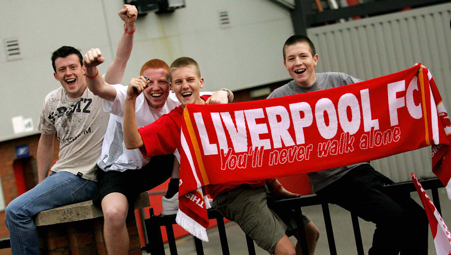 JOHN D MCHUGH/GettyImages Young fans cheers Liverpool as the pass