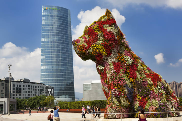 Puppy kissing the Iberdrola skyscraper at the Guggenheim Museum Bilbao