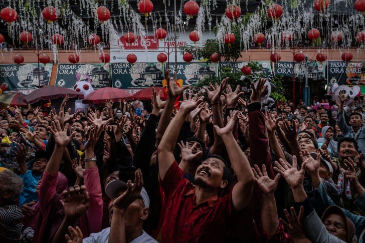 People crowd on the street during the Grebeg Sudiro festival in Solo City, Central Java, Indonesia. Grebeg Sudiro festival is held as a prelude to the Chinese New Year; people bring offerings known as gunungan.