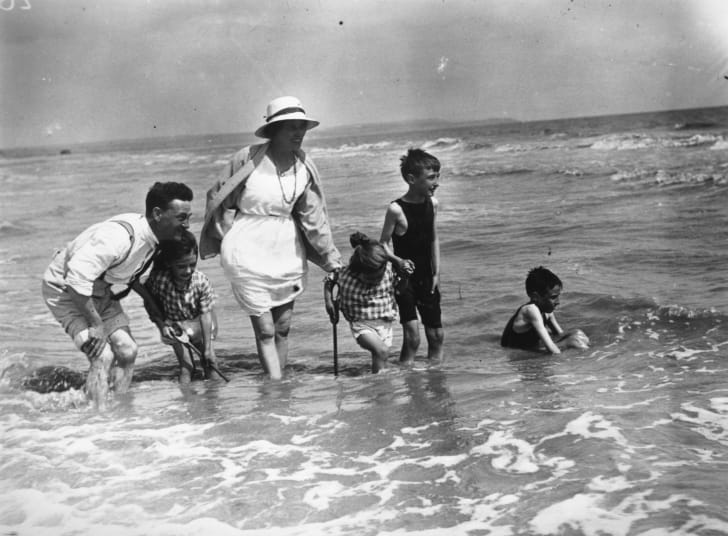 A family plays in the water in 1922.