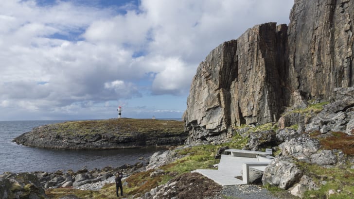 A wide view of a rest stop at the base of a coastal mountain