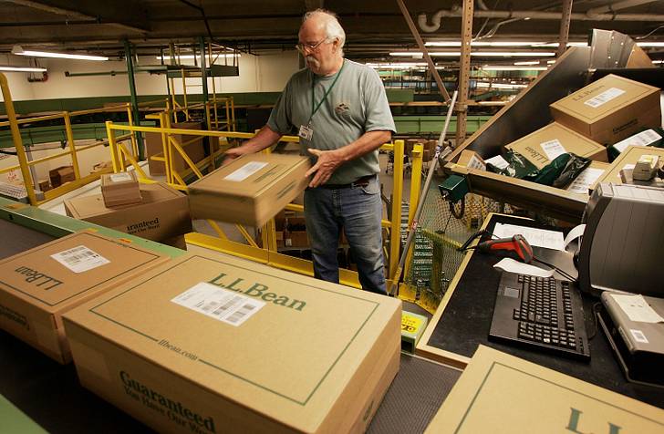 A man surrounded by LL Bean boxes.