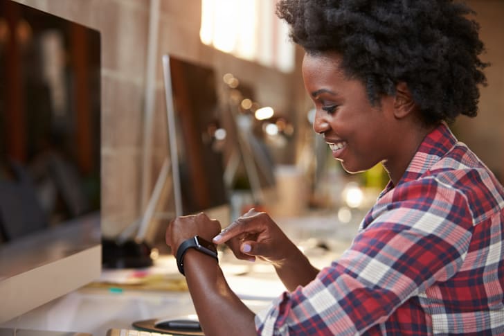 Woman looking at her smart watch.