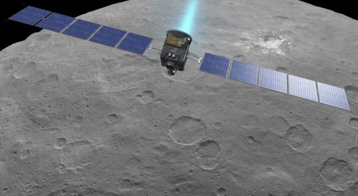 An artist's drawing of Dawn firing its engines above Ceres.