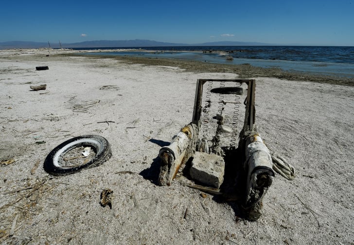 abandoned tire and recliner at salton sea shore