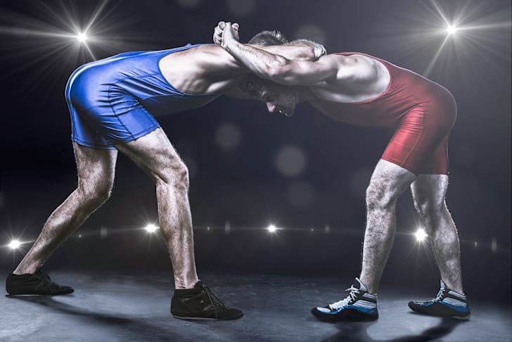 Two wrestlers in stance on stage