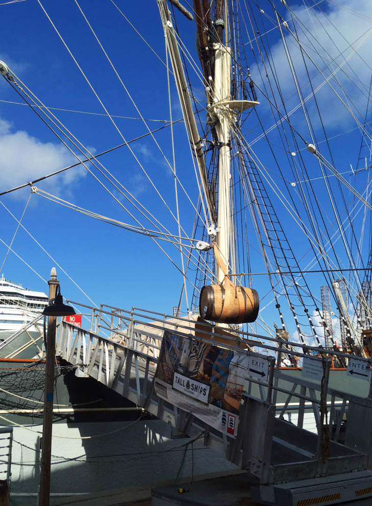 A barrel full of salted beef is loaded into a tall ship