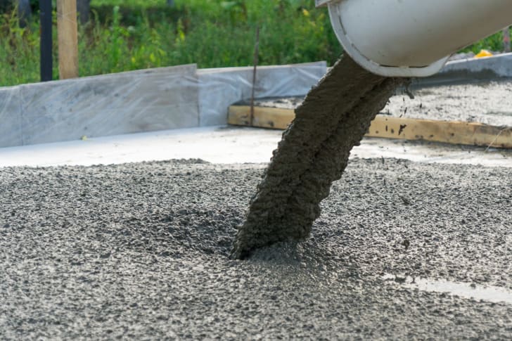 Concrete being poured from tube.