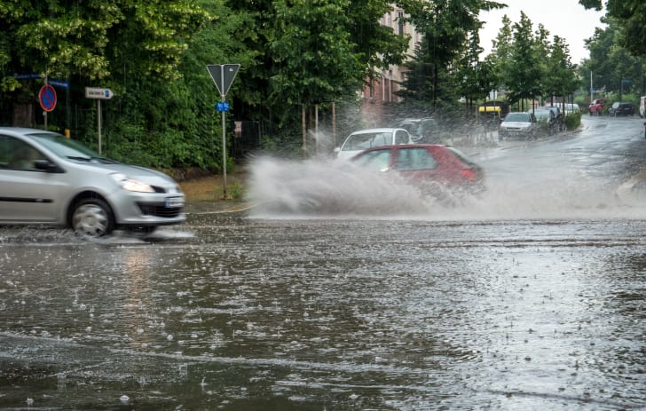 Flooded street with splashing cars
