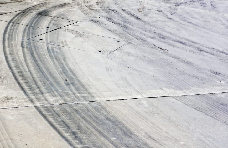 Tire marks on the pavement.
