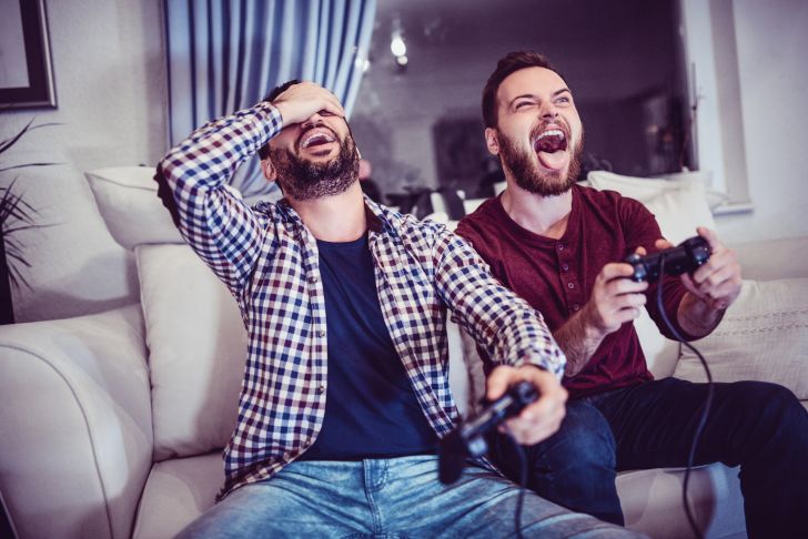 man defeating other man at video games