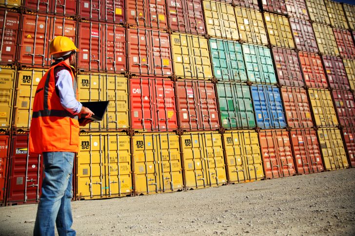 worker examining containers
