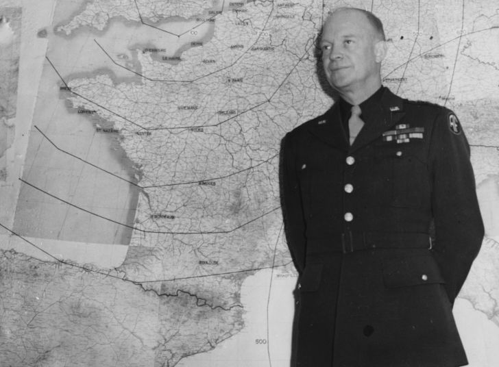 Dwight D. Eisenhower in front of a WWII map.