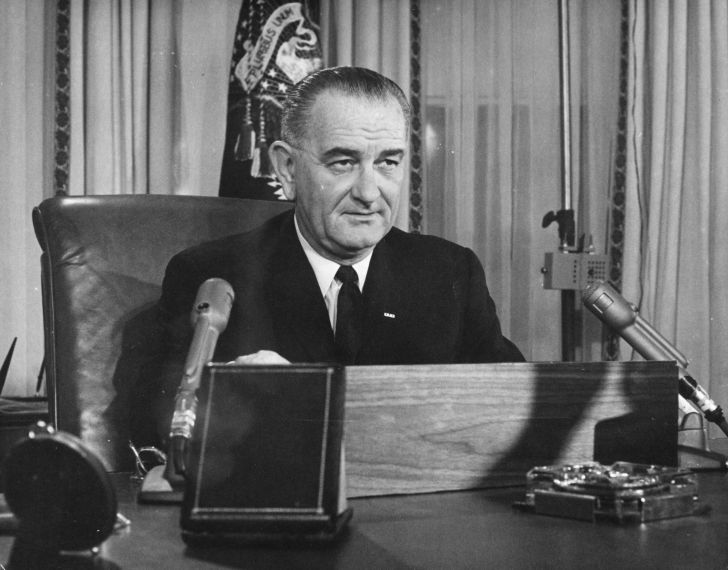 Lyndon B. Johnson behind a podium.